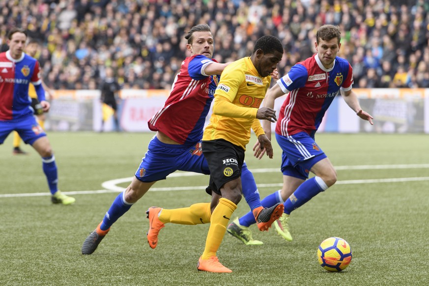 Bern&#039;s Roger Assale, center, fights for the ball against Basel&#039;s Valentin Stocker, left, and Basel&#039;s Fabian Frei, right, during a Super League match between BSC Young Boys Bern and FC B ...