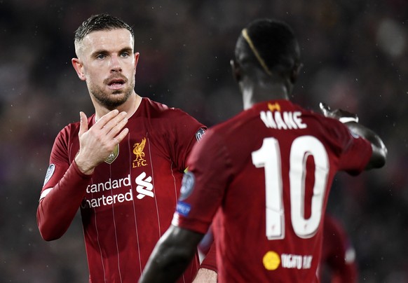 epa08287435 Liverpool captain Jordan Henderson (L) and teammate Sadio Mane during the UEFA Champions League Round of 16, second leg match between Liverpool FC and Atletico Madrid in Liverpool, Britain ...
