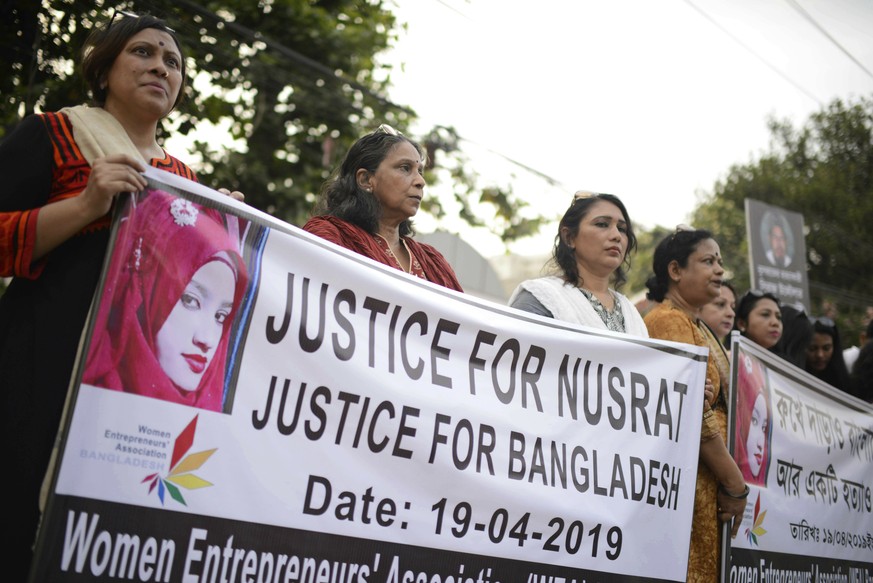 Protesters hold placards and gather to demand justice for an 18-year-old woman who was killed after she was set on fire for refusing to drop sexual harassment charges against her Islamic school&#039;s ...