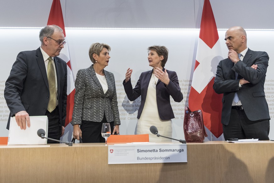 Swiss Federal president Simonetta Sommaruga, second right, and from left, Federal councillors Guy Parmelin, Karin Keller-Sutter and Alain Berset talk after the media briefing about the latest measures ...
