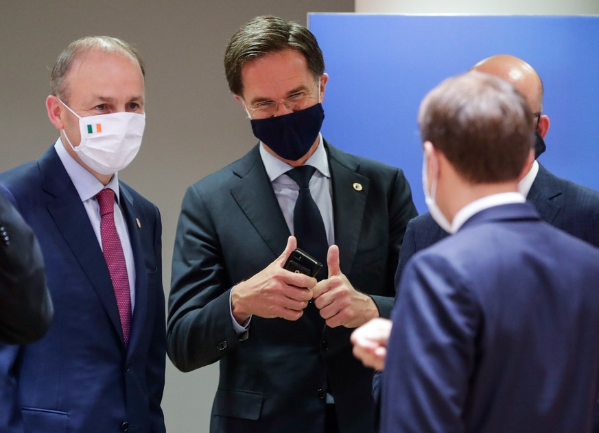 epa08557644 Ireland&#039;s Taoiseach Micheal Martin (L), Dutch Prime Minister Mark Rutte (C) and French President Emmanuel Macron (R) converse during a last roundtable discussion following a four days ...