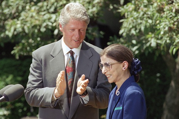 FILE - In this June 15, 1993, file photo, President Bill Clinton applauds as Judge Ruth Bader Ginsburg prepares to speak in the Rose Garden of the White House,after the president announced he would no ...