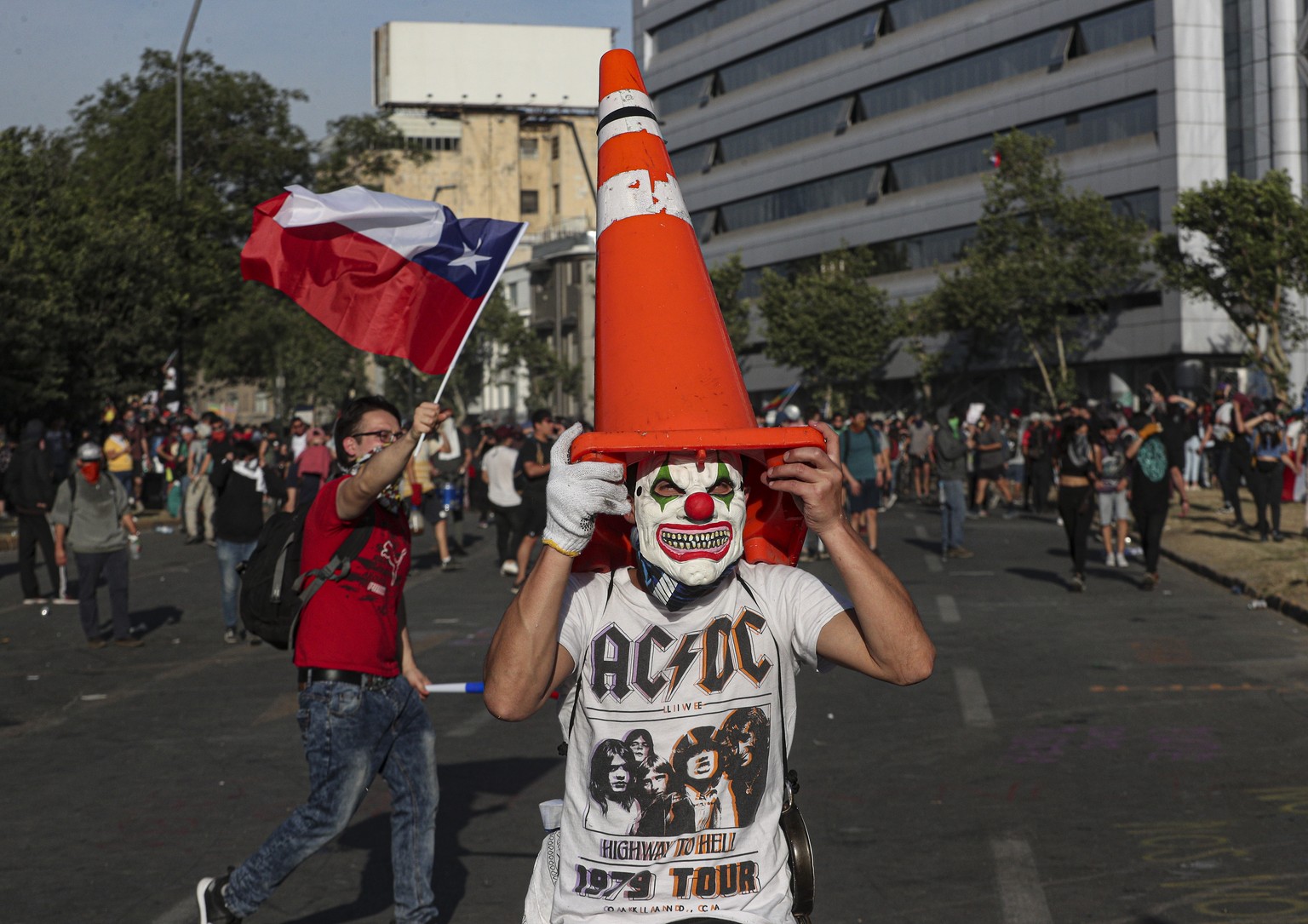 Anti-government protesters block streets in Santiago, Chile, Wednesday, Oct. 30, 2019. Chilean President Sebastián Pinera cancelled two major international summits after nearly two weeks of nationwide ...