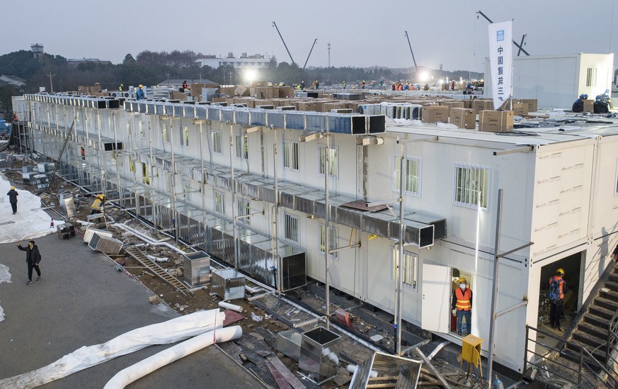 This Saturday, Feb. 1, 2020, photo released by China&#039;s Xinhua News Agency, shows construction workers at the site of the Huoshenshan temporary field hospital being built in Wuhan in central China ...