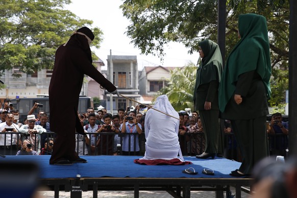 epa07412527 An Acehnese woman faces a public caning punishment for having a sex relationship without being married, in Banda Aceh, Aceh, Indonesia, 04 March 2019. Aceh is the only province in Indonesi ...