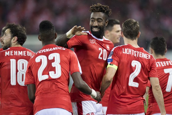 Swiss soccer players Admir Mehmedi, Edimilson Fernandes, Johan Djourou, and Stephan Lichtsteiner, from left to right, celebrate after the second goal, during the 2018 Fifa World Cup group B qualificat ...