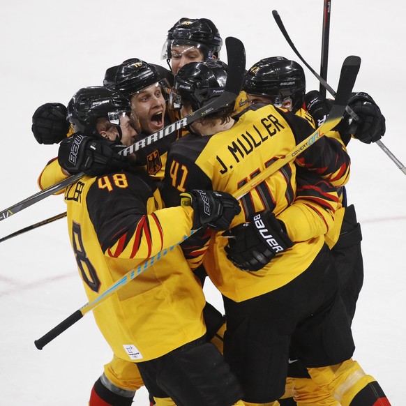 Jonas Muller (41), of Germany, celebrates with teammates after scoring a goal during the third period of the men&#039;s gold medal hockey game against the Olympic athletes from Russia at the 2018 Wint ...
