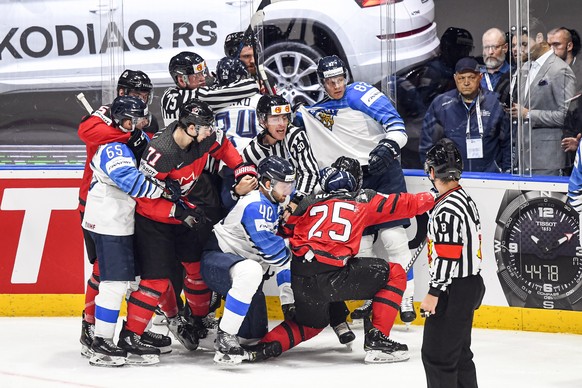 epa07603731 Players of Canada (red) and Finland (blue) in action during the IIHF World Championship ice hockey final between Canada and Finland at the Ondrej Nepela Arena in Bratislava, Slovakia, 26 M ...