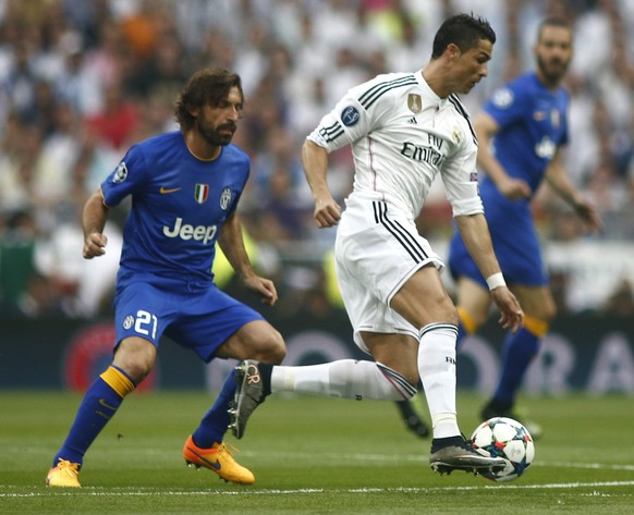 Real Madrid&#039;s Cristiano Ronaldo fights for the ball against Juventus&#039; Andrea Pirlo during the Champions League second leg semifinal soccer match between Real Madrid and Juventus, at the Sant ...