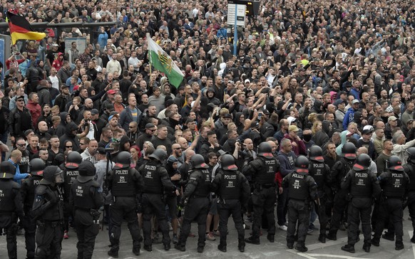 Demonstrators shout during a far-right protest in Chemnitz, Germany, Monday, Aug. 27, 2018 after a man died and two others were injured in an altercation between several people of &quot;various nation ...