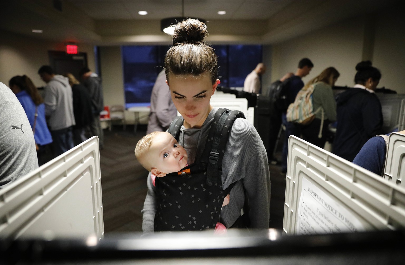Kristen Leach votes with her six-month-old daughter, Nora, on election day in Atlanta, Tuesday, Nov. 6, 2018. (AP Photo/David Goldman)