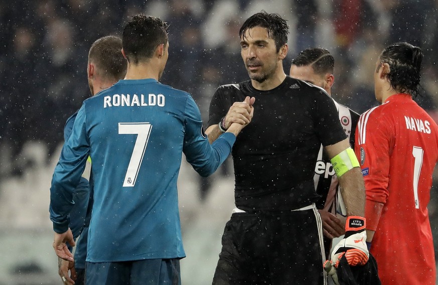 Juventus goalkeeper Gianluigi Buffon, right, shakes hands with Real Madrid&#039;s Cristiano Ronaldo after the Champions League, round of 8, first-leg soccer match between Juventus and Real Madrid at t ...