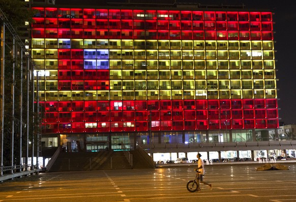 epa06148987 The red and yellow stripes of the Spanish flag are displayed on the Tel Aviv municipality building in Rabin Square in Tel Aviv, Israel, 17 August 2017 honouring the 12 people killed and so ...