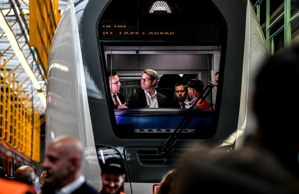 epa07567662 German Minister of Transport Andreas Scheuer (C) and Michael Fohrer (L), CEO of German Bombardier tour the inside of a double-decker train at the Bombardier Transportation plant in Bautzen ...