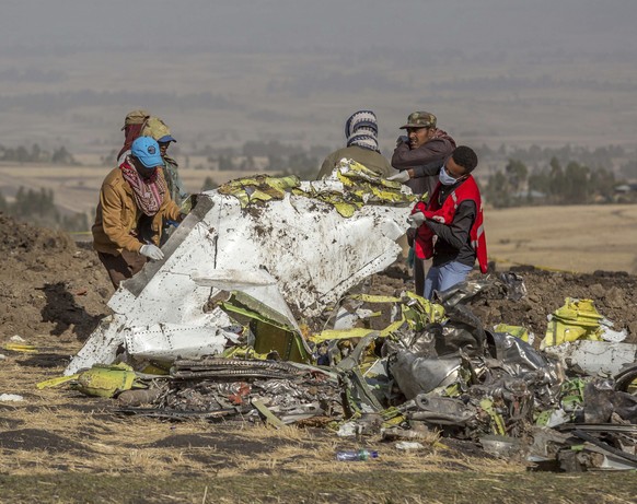 Rescuers work at the scene of an Ethiopian Airlines flight crash near Bishoftu, or Debre Zeit, south of Addis Ababa, Ethiopia, Monday, March 11, 2019. A spokesman says Ethiopian Airlines has grounded  ...