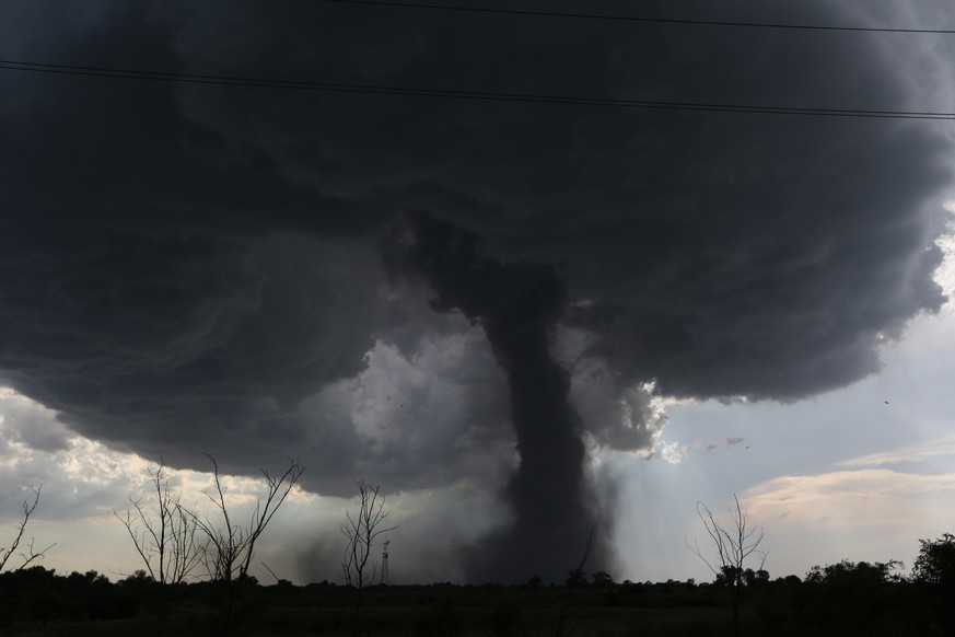 AP10ThingsToSee - A tornado builds and travels southwest causing damage near Dean Rd. and 82nd Avenue in Hutchinson, Kan. on Monday, July 13, 2015. (Sandra J. Milburn/The Hutchinson News via AP)