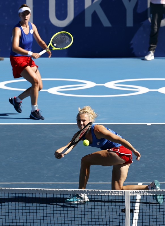 epa09384230 Barbora Krejcikova (L) and Katerina Siniakova (R) of Czech Republic in action during the Women&#039;s Doubles gold medal match during the Tennis events of the Tokyo 2020 Olympic Games at t ...