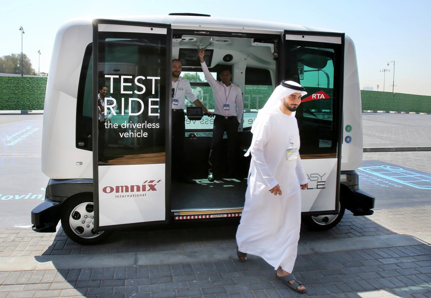 An Emirati visitors gets off a ten-seater driverless car after a test run during the second Middle East and North Africa, MENA, Transport Congress Exhibition in Dubai, United Arab Emirates, Tuesday, A ...