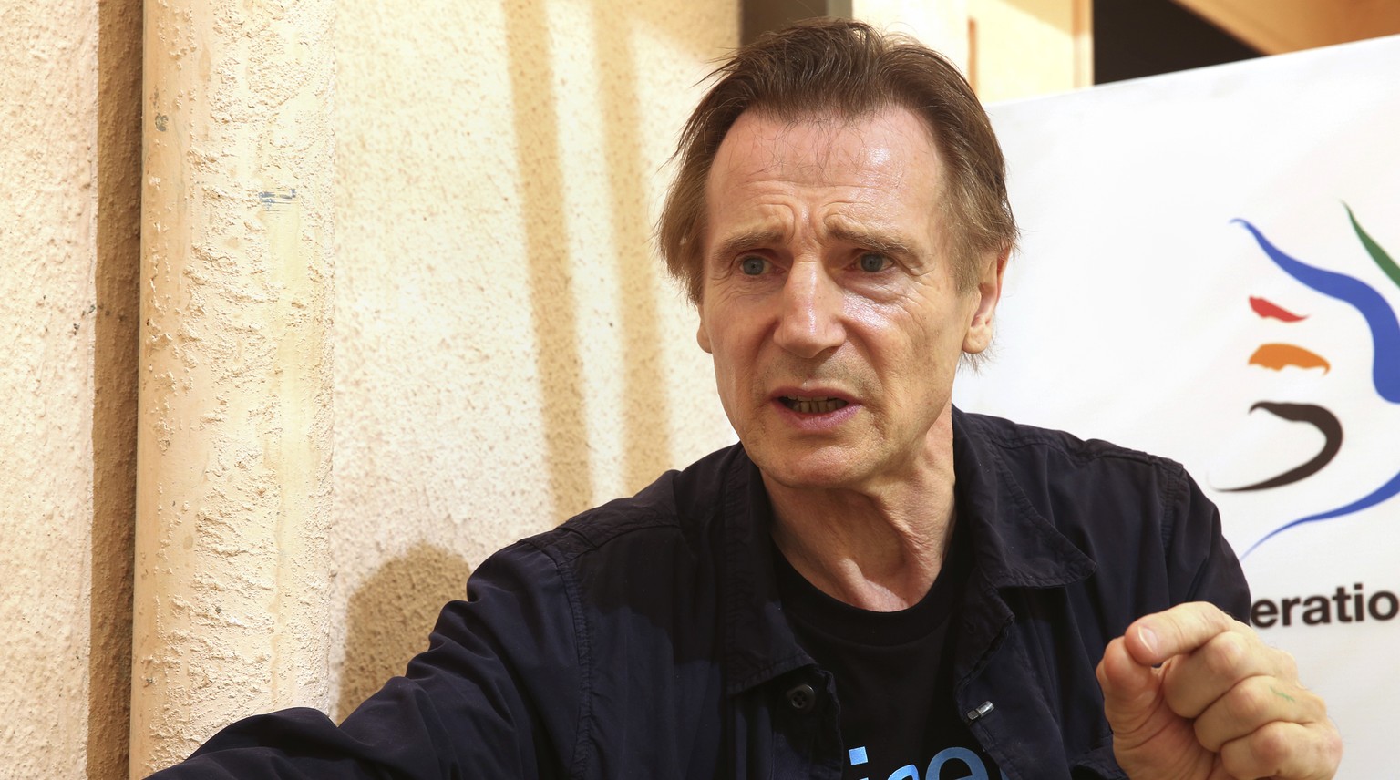 In this Tuesday, Nov. 8, 2016 photo, actor Liam Neeson, speaks during an interview at a community center in a working-class neighborhood of Amman, Jordan. Neeson met with young Syrian refugees in Jord ...