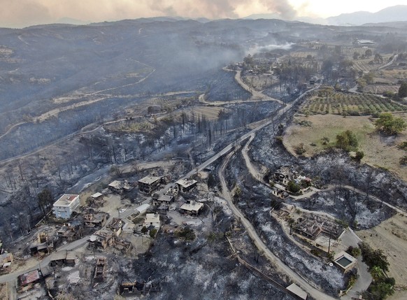 An aerial photo shows destroyed houses in a village as wildfire continue to rage the forests near the Mediterranean coastal town of Manavgat, Antalya, Turkey, Thursday, July 29, 2021. Authorities evac ...