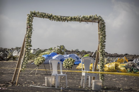 Wreaths and floral installations stand next to piles of wreckage at the scene where the Ethiopian Airlines Boeing 737 Max 8 crashed shortly after takeoff on Sunday killing all 157 on board, near Bisho ...