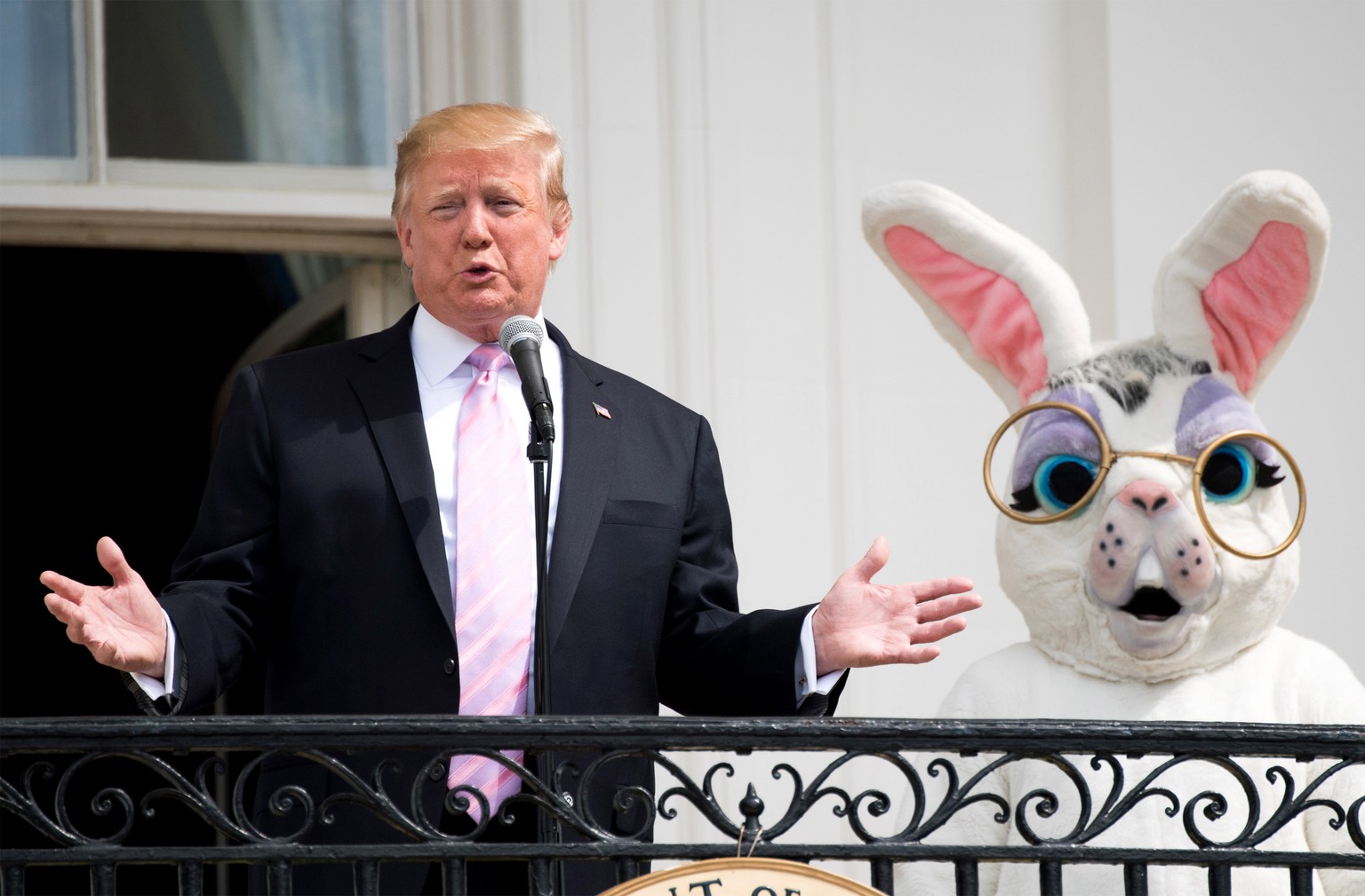 epa07521635 US President Donald J. Trump, accompanied by the Easter Bunny, delivers remarks at the White House Easter Egg Roll at the White House in Washington, DC, USA, on 22 April 2019. Some of this ...