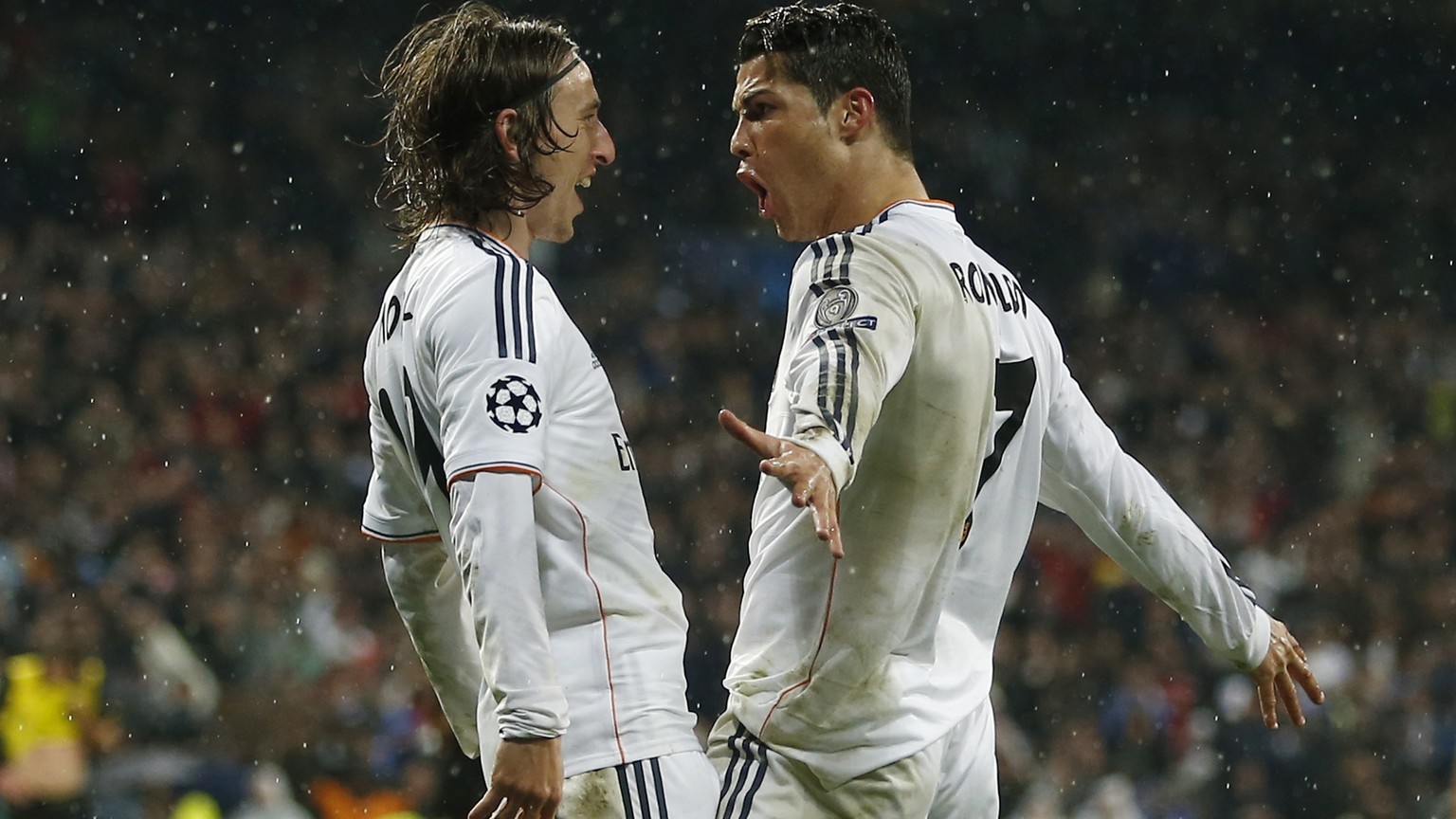 Real&#039;s Cristiano Ronaldo, right, celebrates with Luka Modric after scoring his side&#039;s 3rd goal during a Champions League quarterfinal first leg soccer match between Real Madrid and Borussia  ...