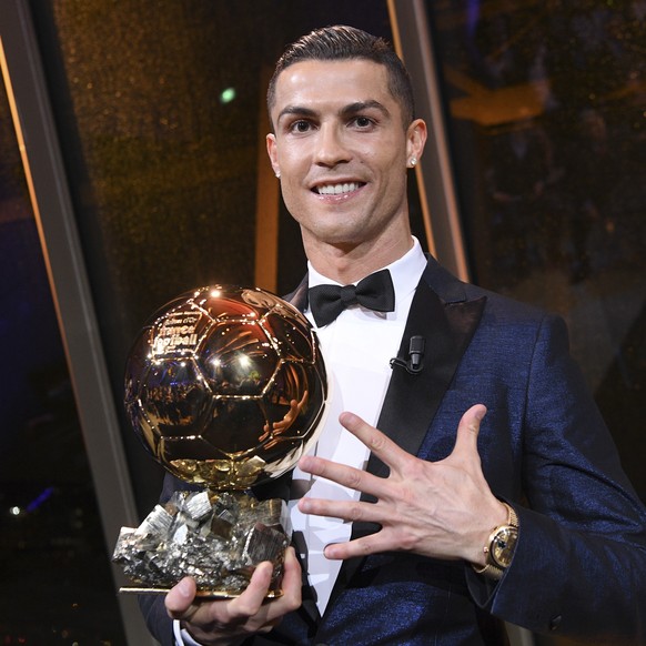 This image provided by L&#039;Equipe Friday Dec.8, 2017 shows Portuguese soccer player Christiano Ronaldo holding the Ballon d&#039; Or (Golden Ball) he received Thursday Dec.7, 2017 in Paris. A decad ...