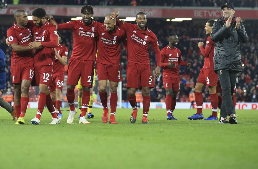 Liverpool coach Juergen Klopp, right, celebrates after Liverpool forward Divock Origi, third from left, scored his side&#039;s first goal at the end of the English Premier League soccer match between  ...