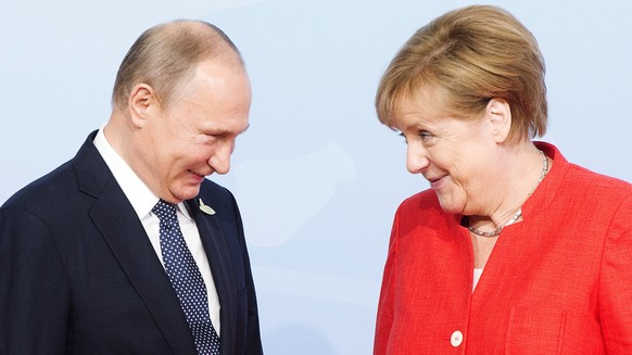 Russian President Vladimir Putin is greeted by German Chancellor Angela Merkel at the official welcoming ceremony at the G20 summit Friday, July 7, 2017 in Hamburg, Germany. (Remiorz/The Canadian Pres ...
