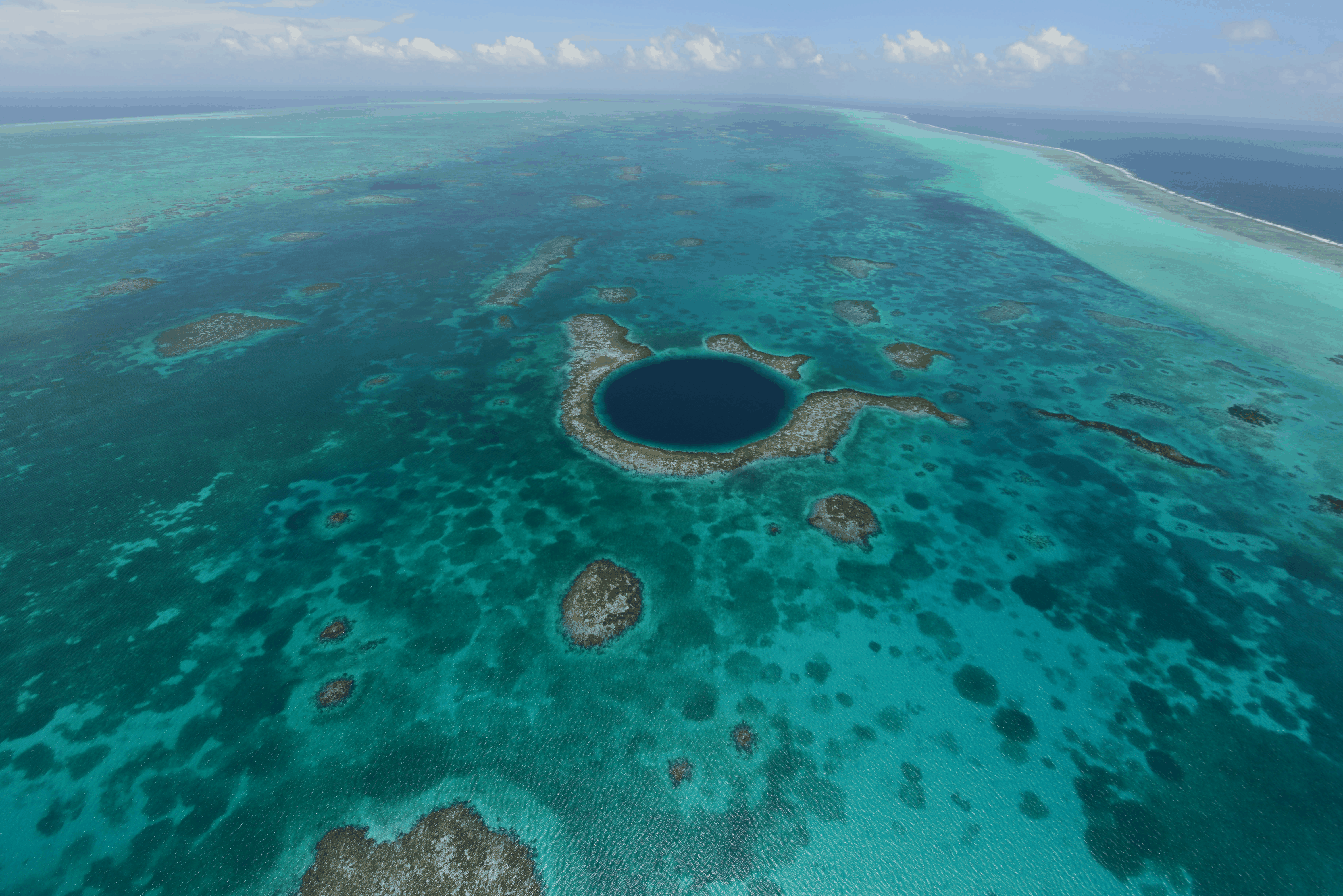 This undated image provided by The Belize Tourist Board shows an aerial view of the Great Blue Hole, a popular diving site that is part of Belize’s barrier reef. The Blue Hole is 1,000 feet (300 meter ...