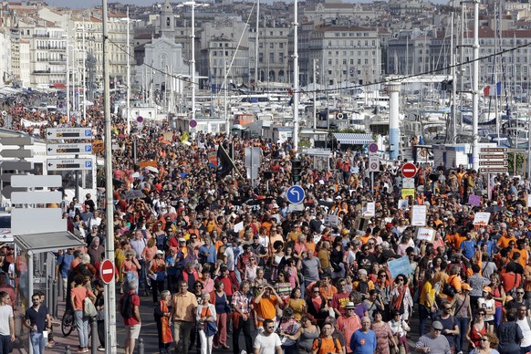 People gather to support the Aquarius ship that rescues migrants operated by the humanitarian group SOS Mediterranee, in the Old-Port of Marseille, southern France, Saturday, Oct. 6, 2018. The Aquariu ...