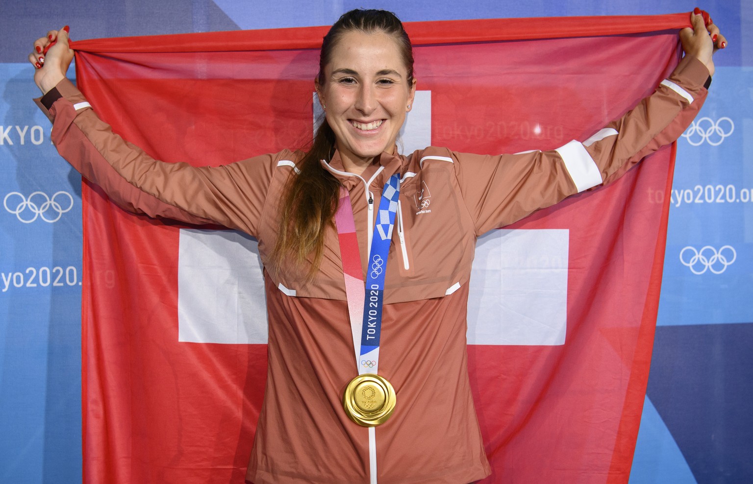 Gold medal winner Belinda Bencic of Switzerland poses with her medal and a Swiss flag after winning the games against Marketa Vondrousova of Czech Republic during the women&#039;s singles tennis gold  ...