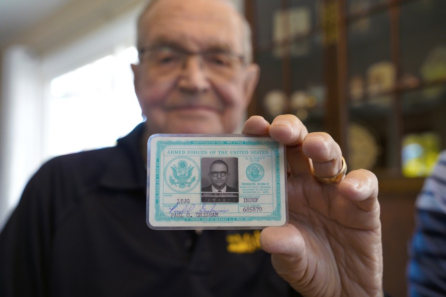 Paul Grisham holds his 1968 Navy ID card at his home in the San Carlos neighborhood of San Diego, Calif., Wednesday, Feb. 3, 2021. Grisham