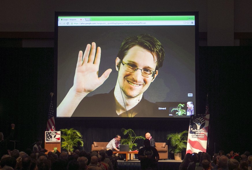 FILE - In this Feb. 14, 2015, file photo, Edward Snowden appears on a live video feed broadcast from Moscow at an event sponsored by ACLU Hawaii in Honolulu. Snowden blew the lid off U.S. government s ...