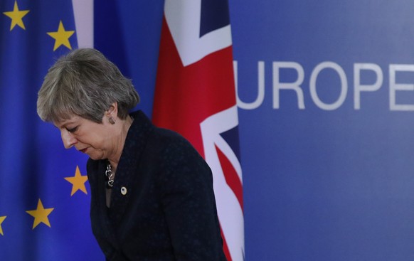 FILE - In this Friday, March 22, 2019 file photo, British Prime Minister Theresa May leaves after addressing a media conference at an EU summit in Brussels. May is off to Brussels to ask for a delay t ...