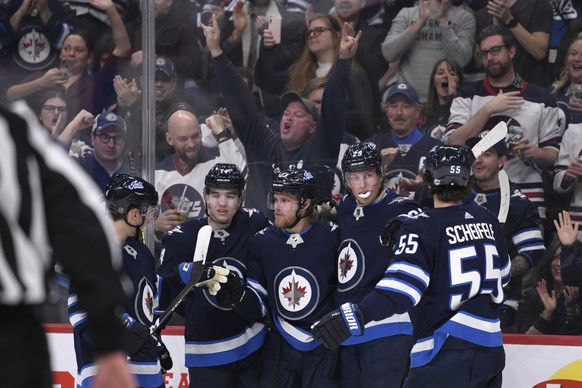 Winnipeg Jets&#039; Nikolaj Ehlers, middle, celebrates his goal against the Los Angeles Kings with Ville Heinola (14), Patrik Laine (29) and Mark Scheifele (55) during the second period of an NHL hock ...