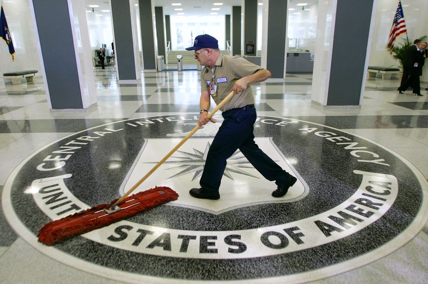 FILE - In this March 3, 2005 file photo, a workman slides a dustmop over the floor at the Central Intelligence Agency headquarters in Langley, Va. Senate investigators have delivered a damning indictm ...