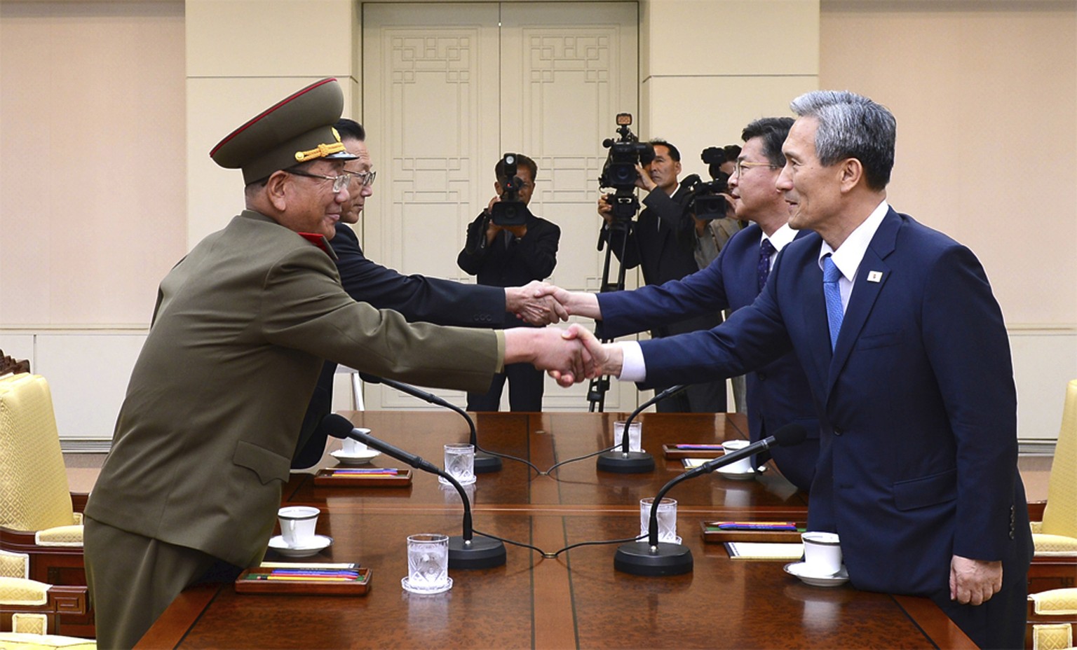 FILE - In this Aug. 22, 2015 file photo provided by the South Korean Unification Ministry, South Korean National Security Director, Kim Kwan-jin, right, and Unification Minister Hong Yong-pyo, second  ...