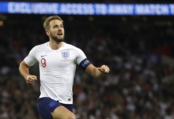 FILE - In this Thursday, Nov. 14, 2019 file photo, England&#039;s Harry Kane, right, celebrates scoring the fifth goal during the Euro 2020 group A qualifying soccer match between England and Monteneg ...