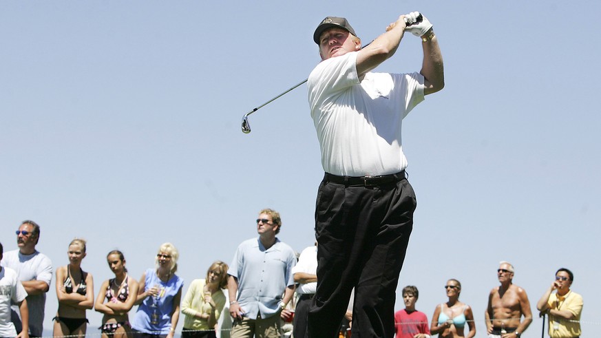 FILE - In this July 17, 2005, file photo, Donald Trump hits off the 17th tee at Edgewood Golf Course during the American Century Championship in Stateline, Nev. A set of golf clubs that Donald Trump g ...