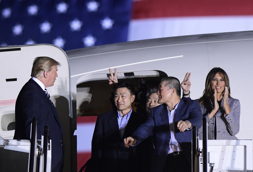 President Donald Trump, from left, greets Tony Kim, Kim Hak Song and Kim Dong Chul, three Americans detained in North Korea for more than a year, as they arrive at Andrews Air Force Base in Md., Thurs ...