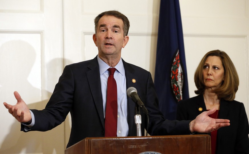 Virginia Gov. Ralph Northam, left, accompanied by his wife, Pam, speaks during a news conference in the Governor&#039;s Mansion in Richmond, Va., on Saturday, Feb. 2, 2019. Resisting widespread calls  ...