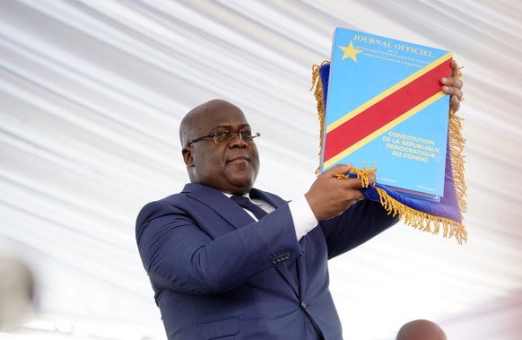 Congolese President Felix Tshisekedi holds the constitution after being sworn in in Kinshasa, Democratic Republic of the Congo, Thursday Jan. 24, 2019. Tshisekedi won an election that raised numerous  ...