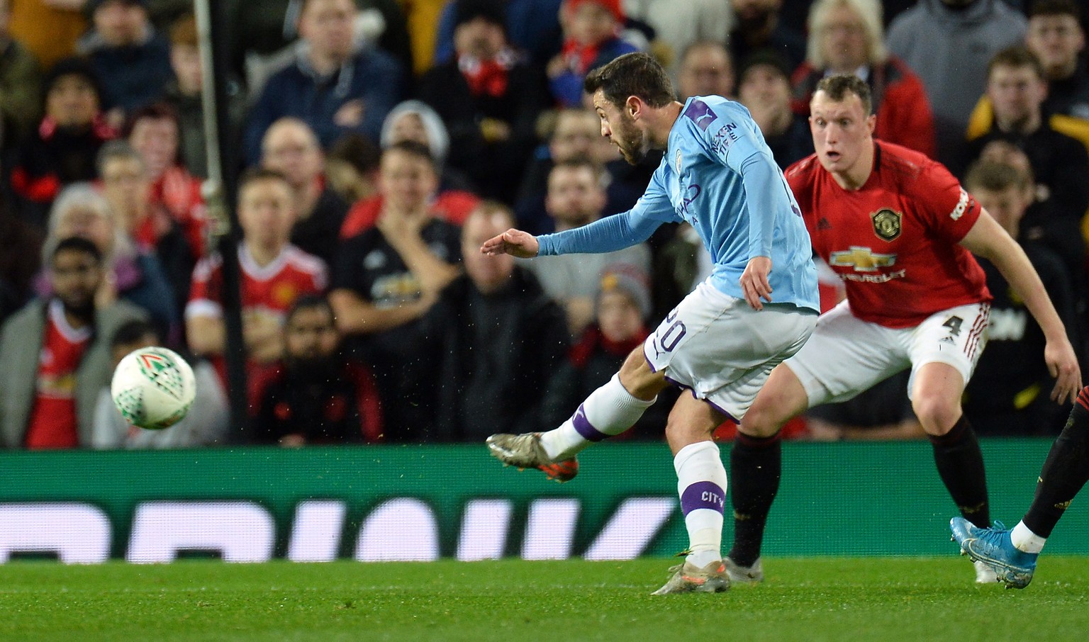 epa08110945 Manchester City&#039;s Bernardo Silva (L) scores during the Carabao Cup first round semi-final soccer match between Manchester United and Manchester City held at Old Trafford in Manchester ...