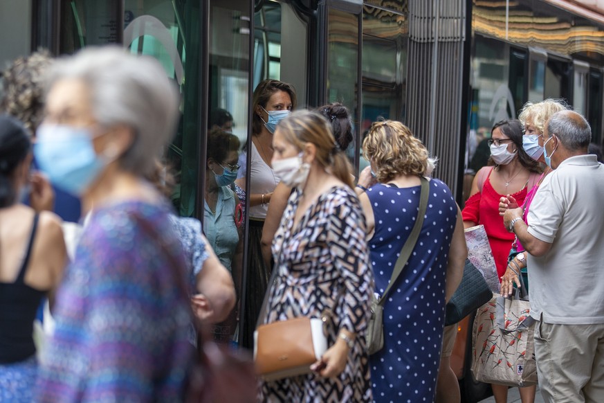 Passengers wearing prospective masks as a precaution against the spread COVID-19 embark and disembark of a bus of theTransports publics genevois, TPG, (English: Geneva Public Transport), during the pa ...