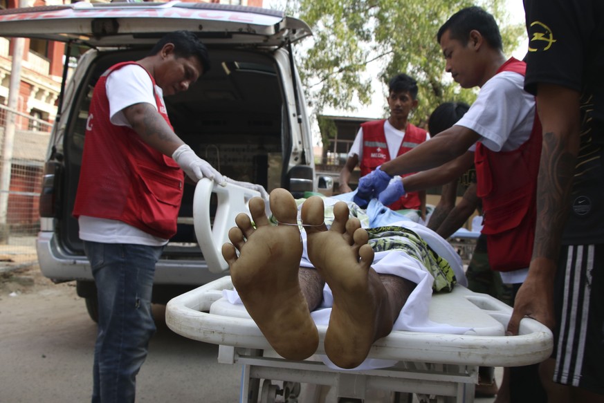 The body of a man killed in an anti-coup protest is brought to a hospital in Latha township, Yangon, Myanmar, Saturday, March 27, 2021. As Myanmar���s military celebrated the annual Armed Forces Day h ...