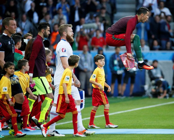 Football Soccer - Portugal v Iceland - EURO 2016 - Group F - Stade Geoffroy-Guichard, Saint-Étienne, France - 14/6/16Portugal&#039;s Cristiano Ronaldo jumps as he leads his team out before the gameREU ...