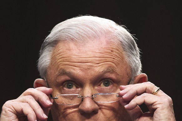 epa07149116 (FILE) - US Attorney General Jeff Sessions puts on his glasses while testifying before the Senate Intelligence Committee on the FBI&#039;s investigation into the Trump administration, and  ...
