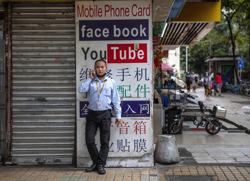 epa08421641 A man uses his phone in front of a store advertising Virtual Private Network (VPN) services and &#039;free internet&#039; SIM cards allowing access to foreign websites that are restricted  ...